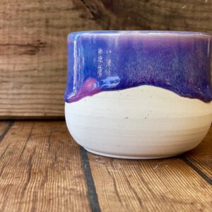 ivory ceramic cup with pink, purple, and light aqua color melt glaze